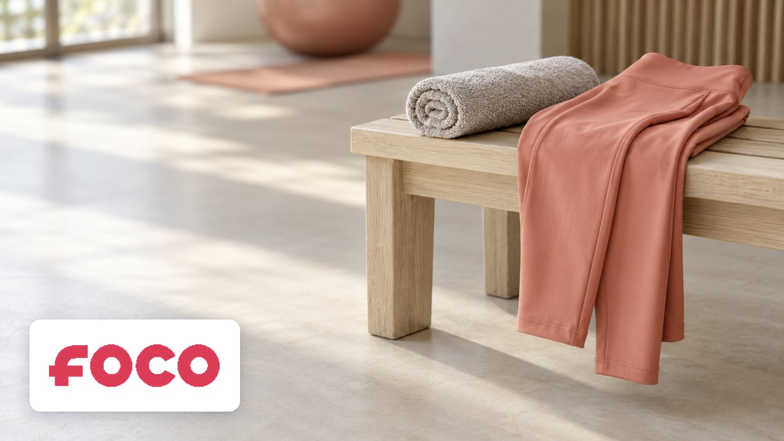 FOCO logo with activewear draped over bench